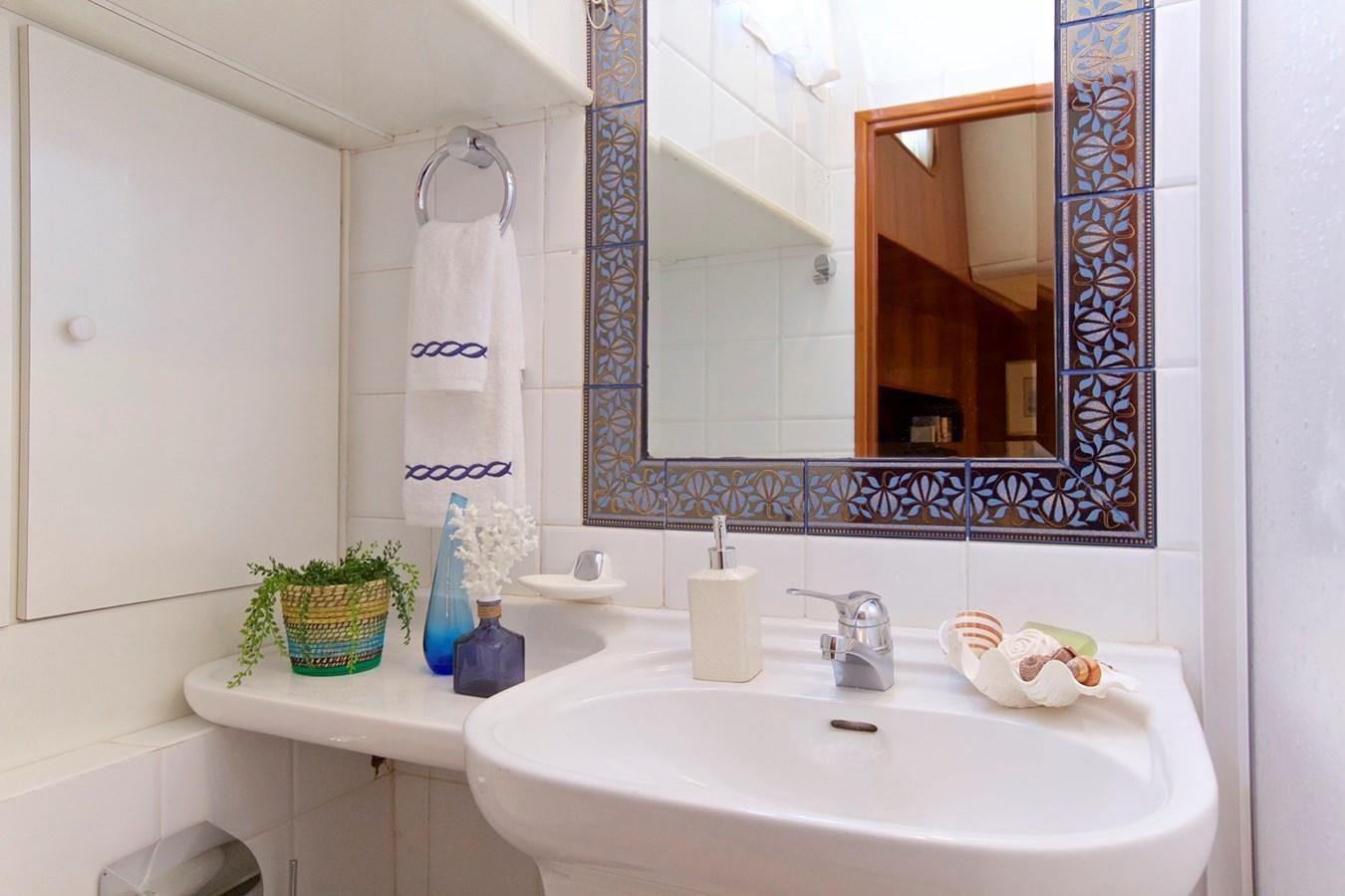 a bathroom with a sink and mirror aboard HERMINA Yacht for Sale