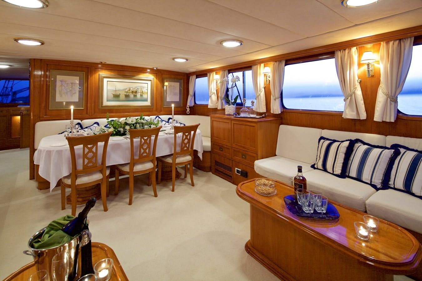 a living room with a table and chairs aboard HERMINA Yacht for Sale