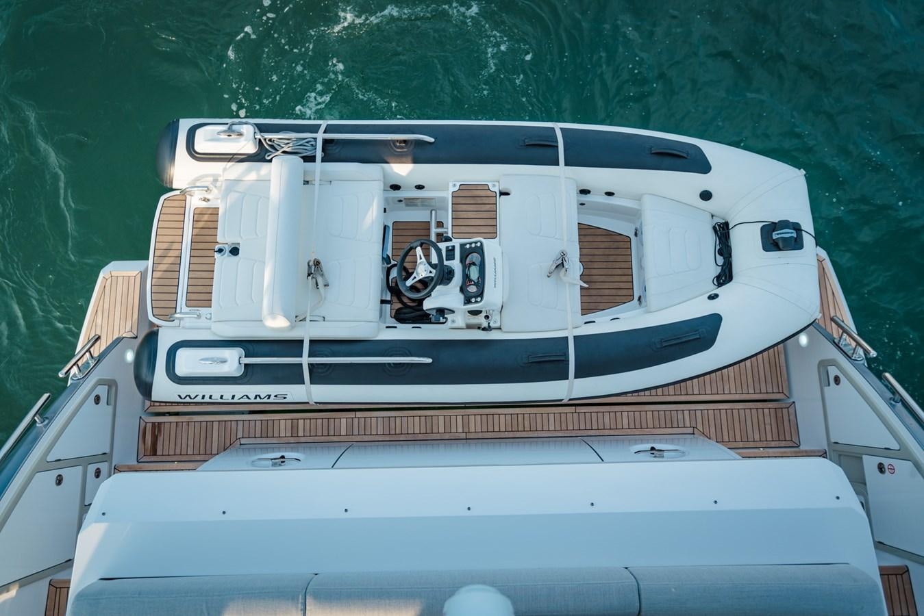a white boat with a steering wheel aboard ATLANTIS Yacht for Sale
