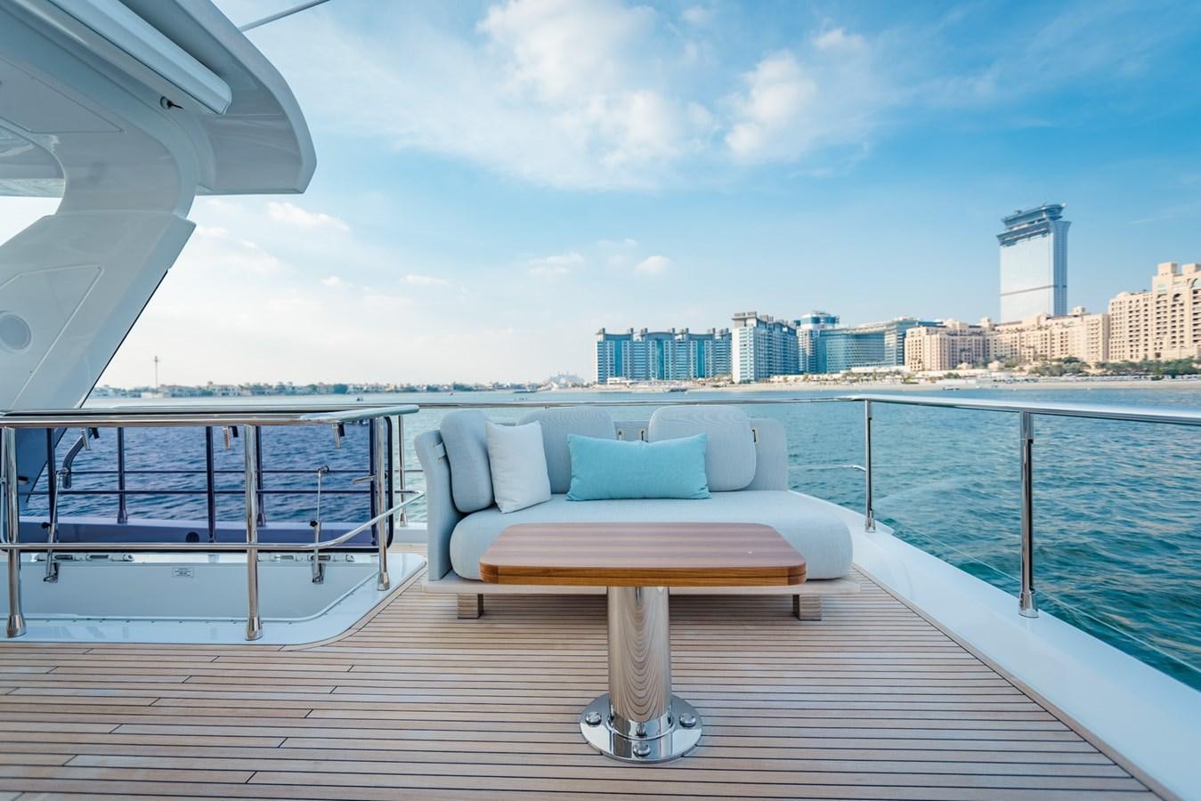 a couch on a deck overlooking a city aboard ATLANTIS Yacht for Sale