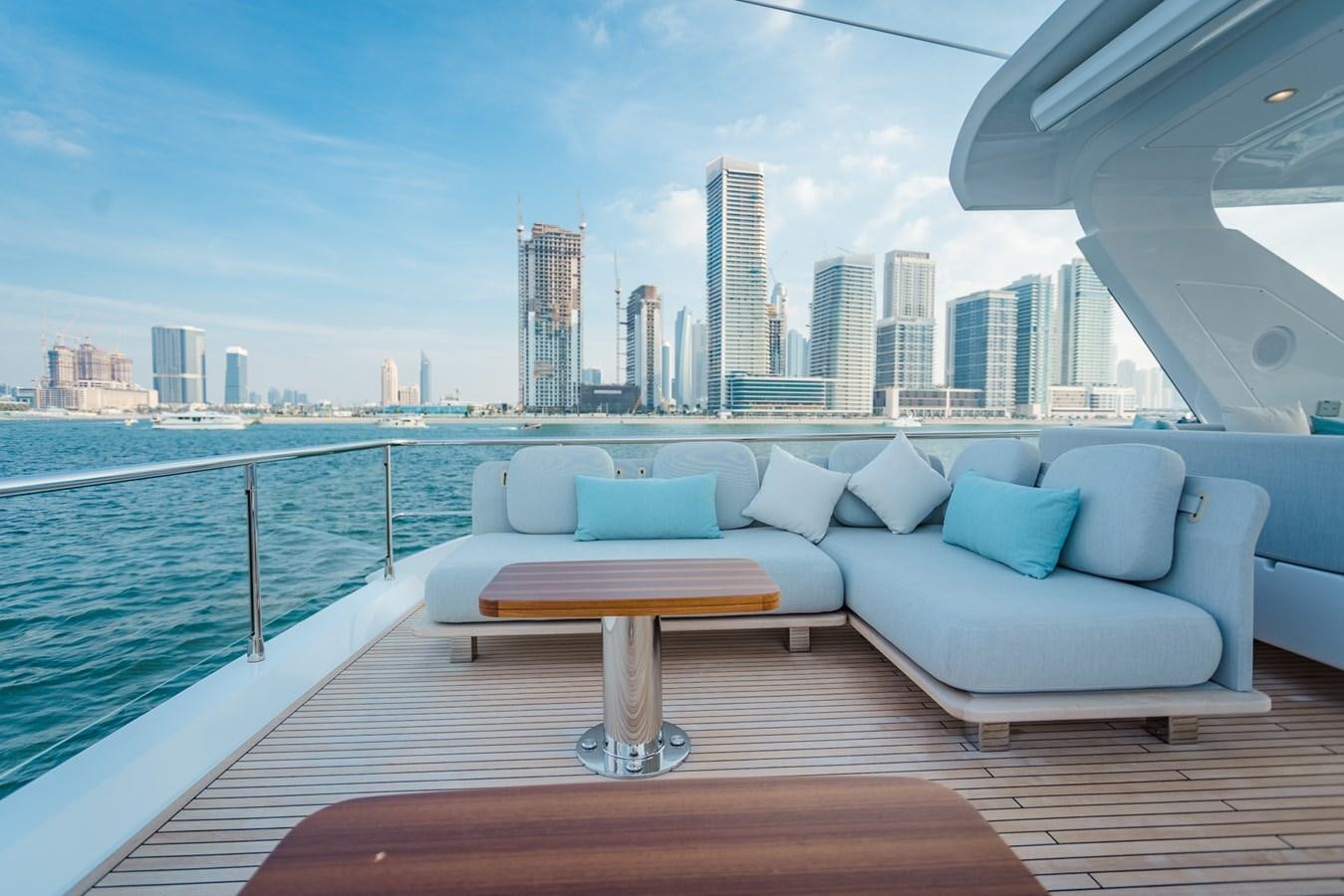 a couch and a table on a boat in a large body of water aboard ATLANTIS Yacht for Sale