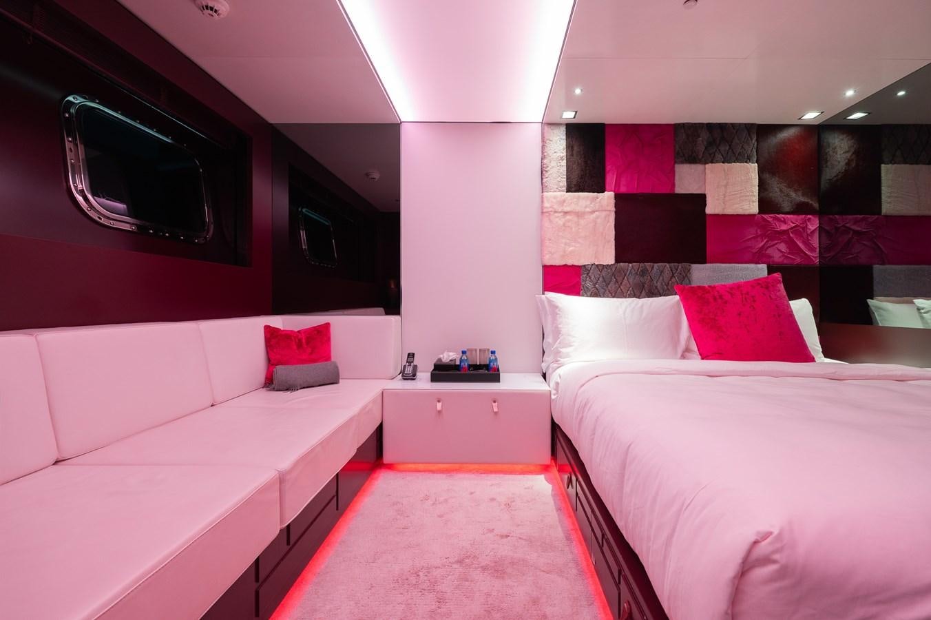a room with beds and a red rug aboard NONNI II Yacht for Sale