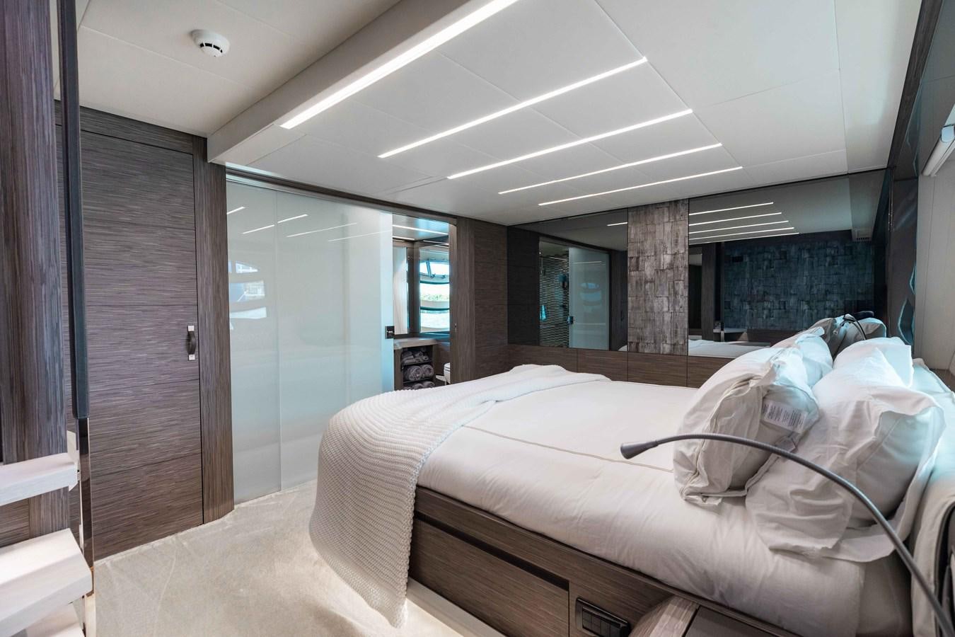 a room with a bed and a wood door aboard AFRICAN WILD DOG Yacht for Sale