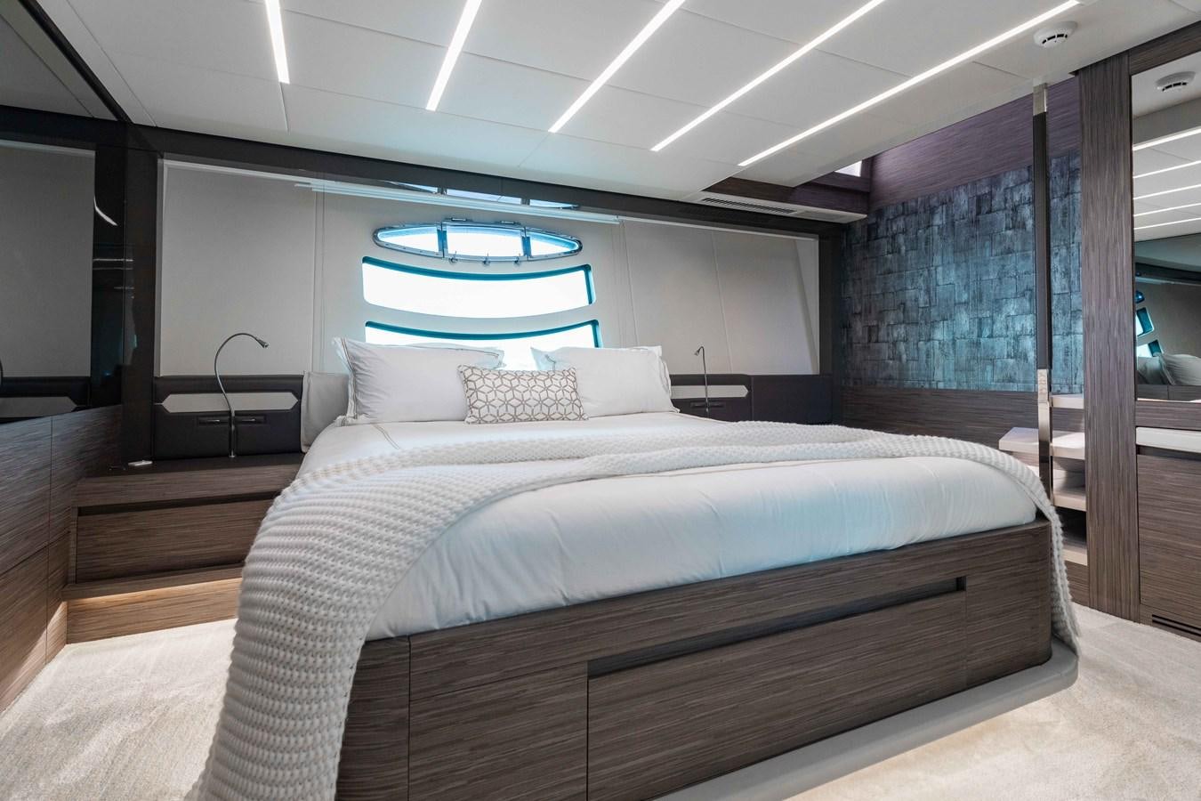 a bed with a white bed spread aboard AFRICAN WILD DOG Yacht for Sale