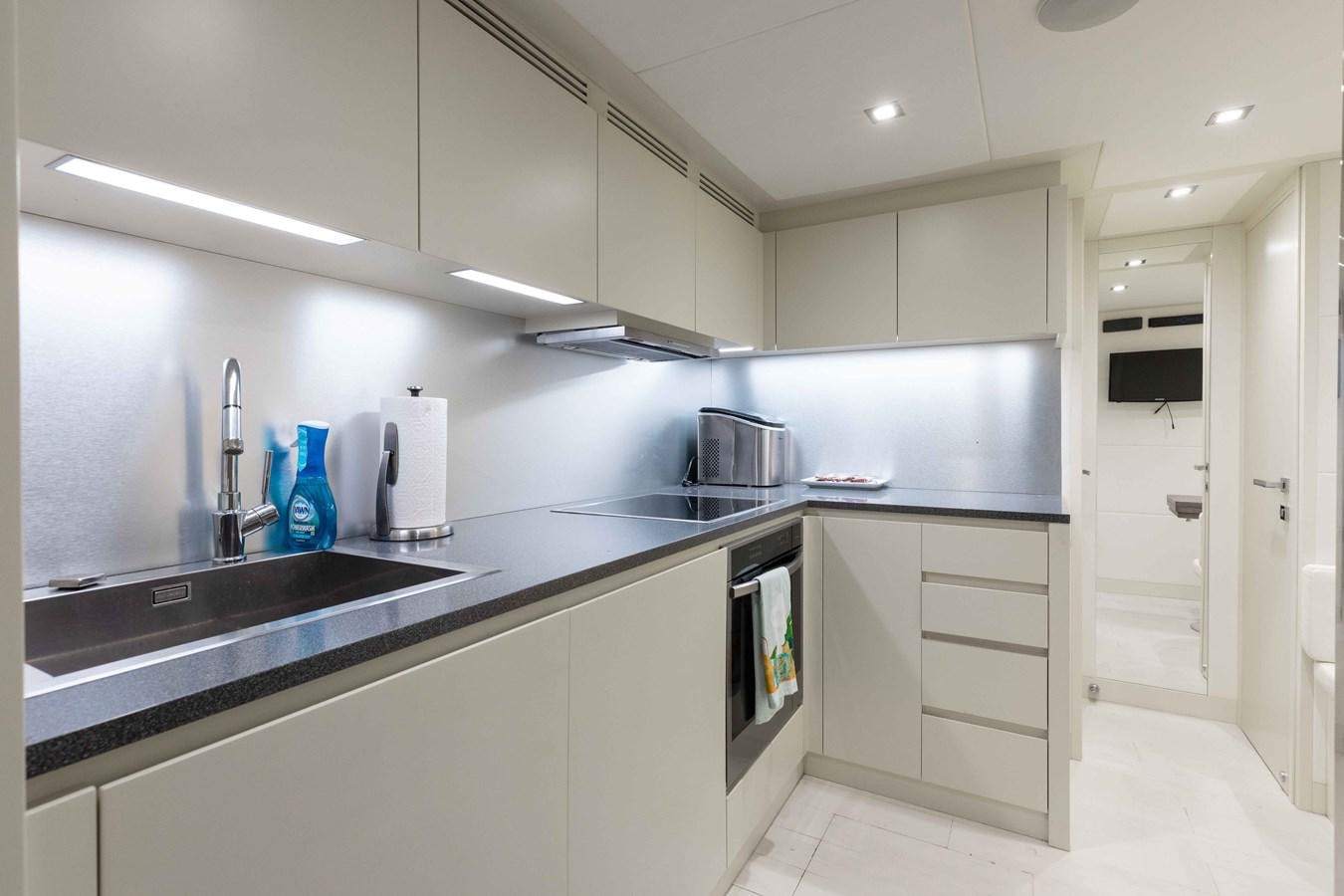 a kitchen with white cabinets aboard AFRICAN WILD DOG Yacht for Sale