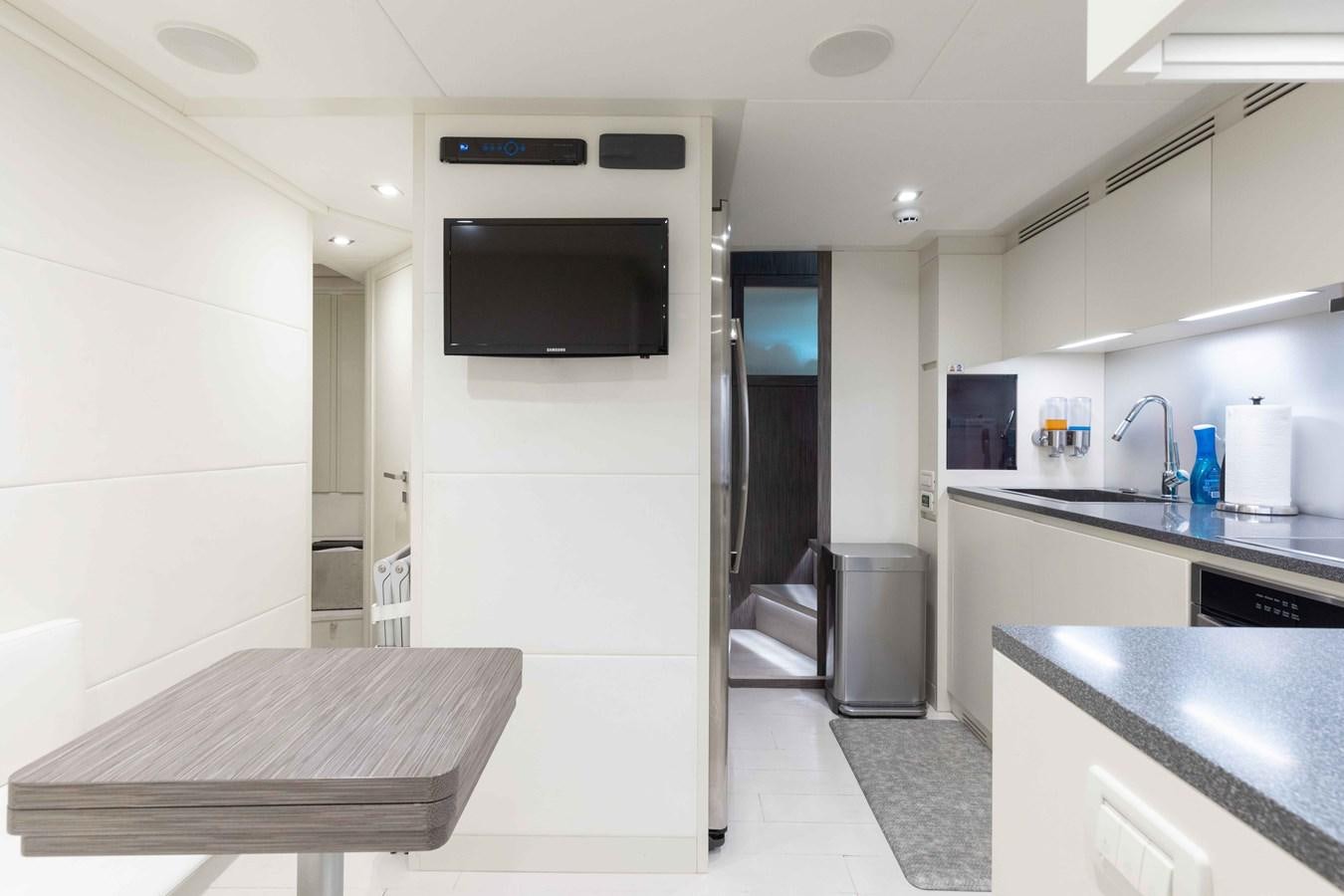 a kitchen with a sink and a tv aboard AFRICAN WILD DOG Yacht for Sale