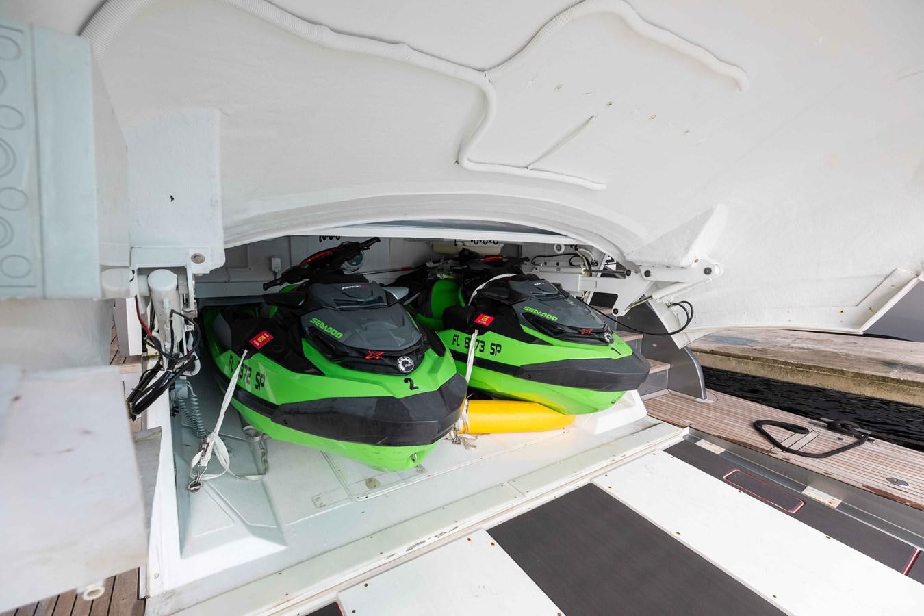 a green and black car inside a white car aboard AFRICAN WILD DOG Yacht for Sale
