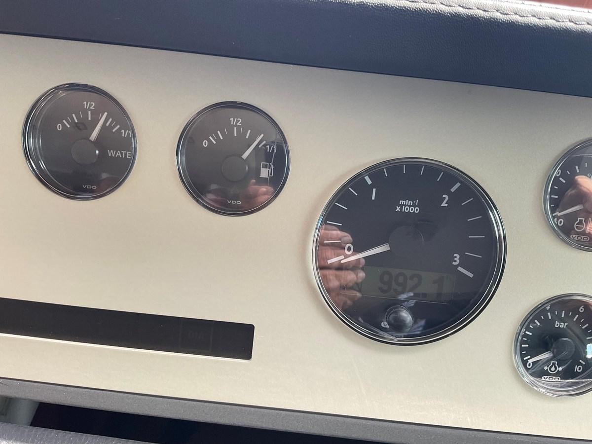 a car dashboard with gauges aboard SQUADRON 78 CUSTOM Yacht for Sale