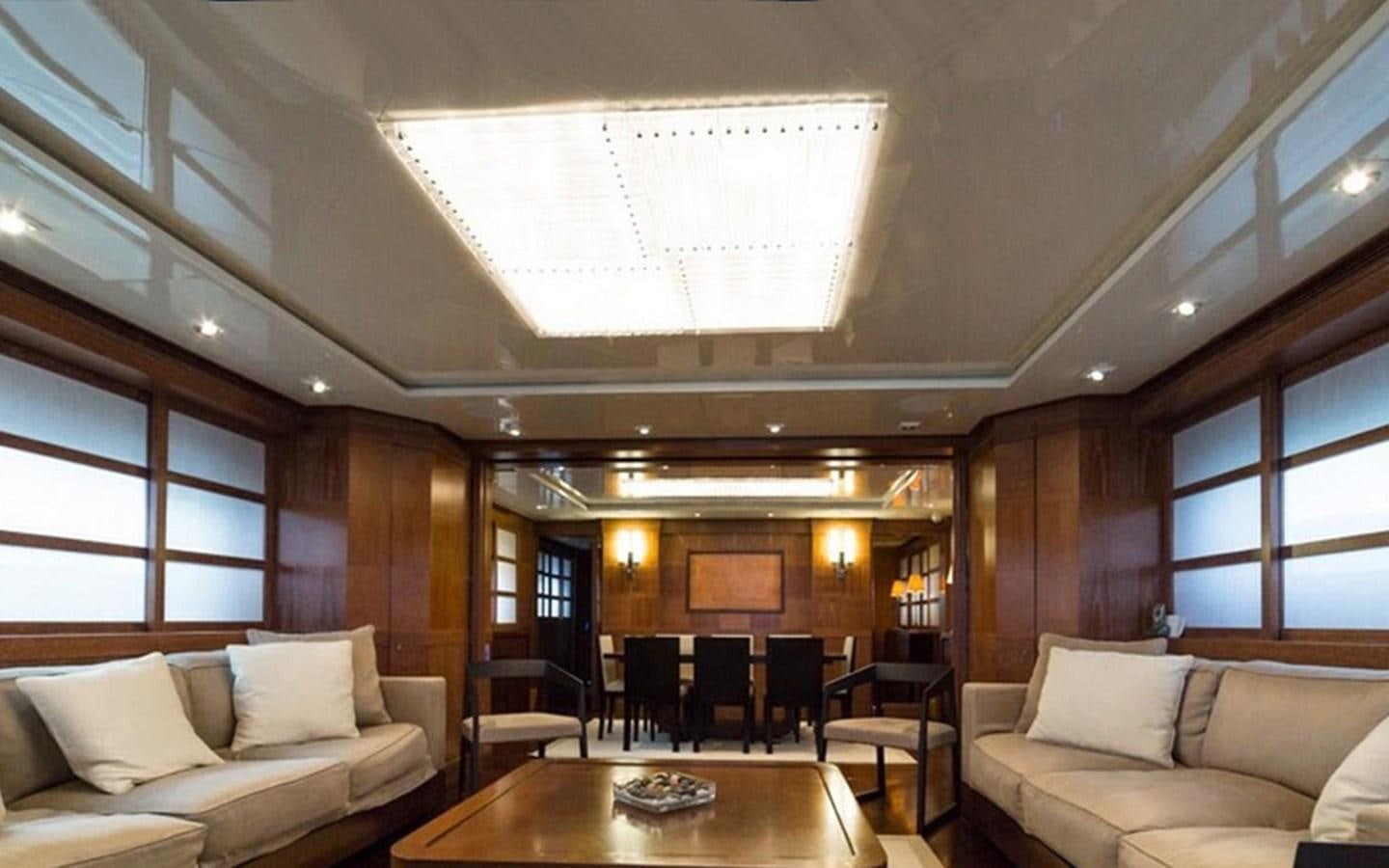 a room with a table and couches aboard ZOO Yacht for Sale