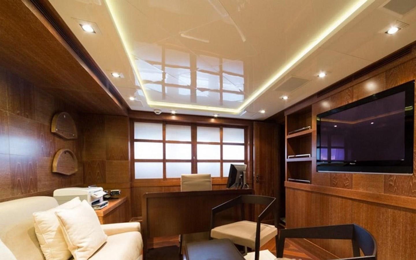 a room with a tv and couches aboard ZOO Yacht for Sale