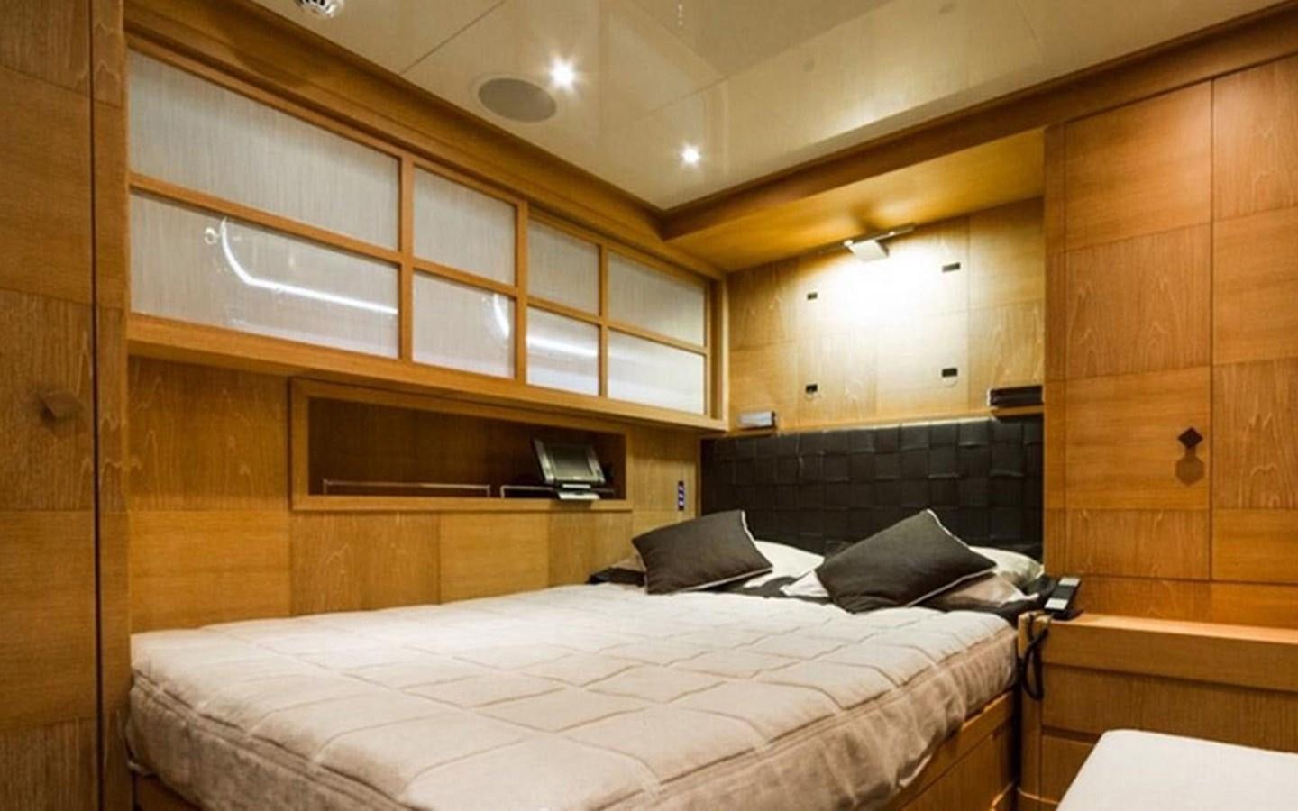 a room with a bed and a television aboard ZOO Yacht for Sale