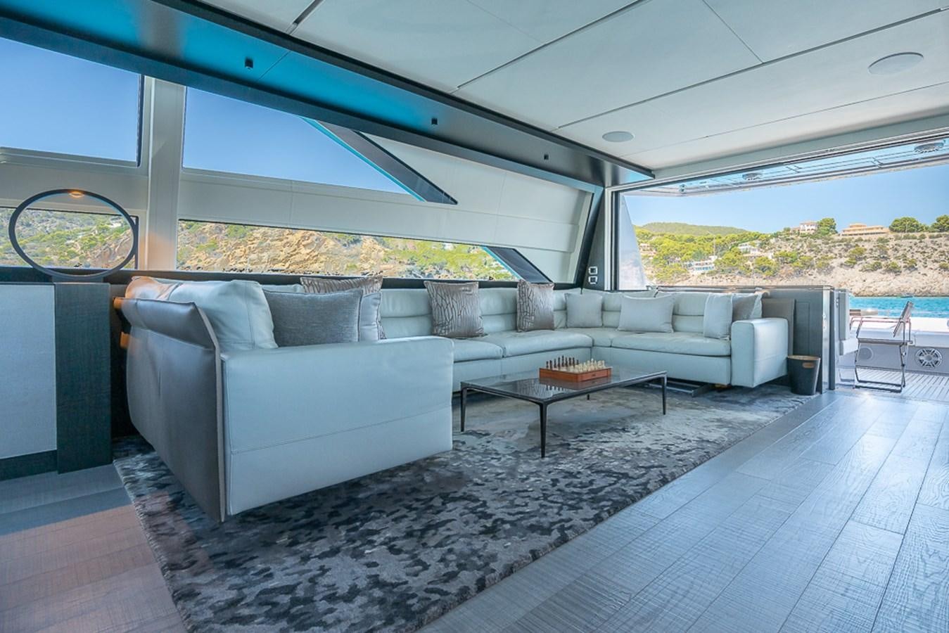 a living room with couches aboard BOMBADIL III Yacht for Sale