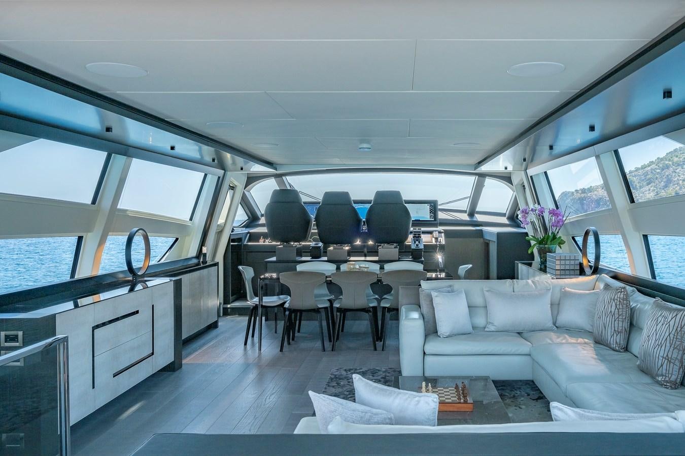 a living room with a couch and chairs aboard BOMBADIL III Yacht for Sale