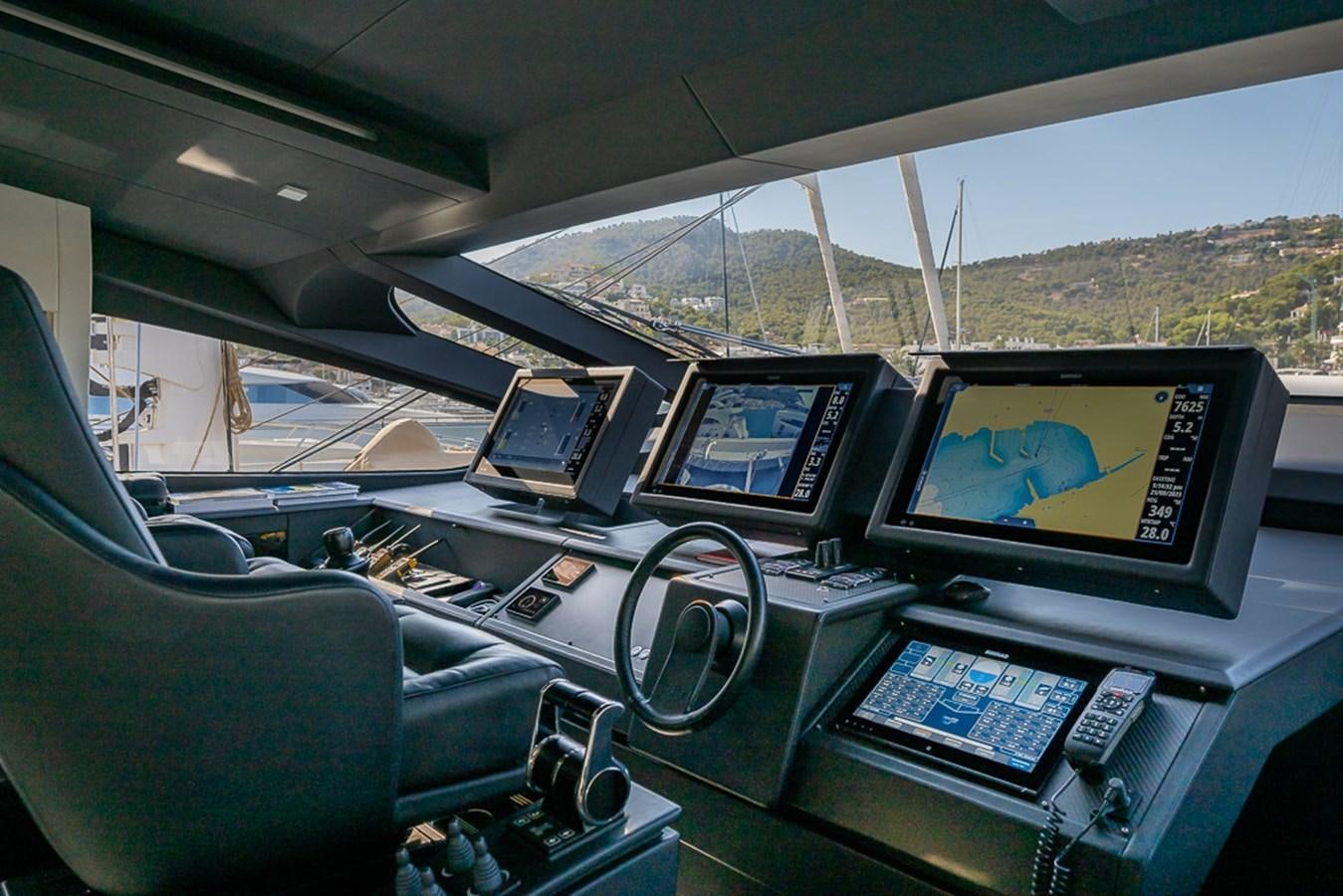 a car with a screen and a monitor on the side aboard BOMBADIL III Yacht for Sale
