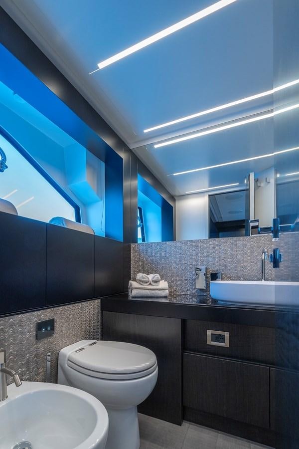 a bathroom with a large mirror aboard BOMBADIL III Yacht for Sale