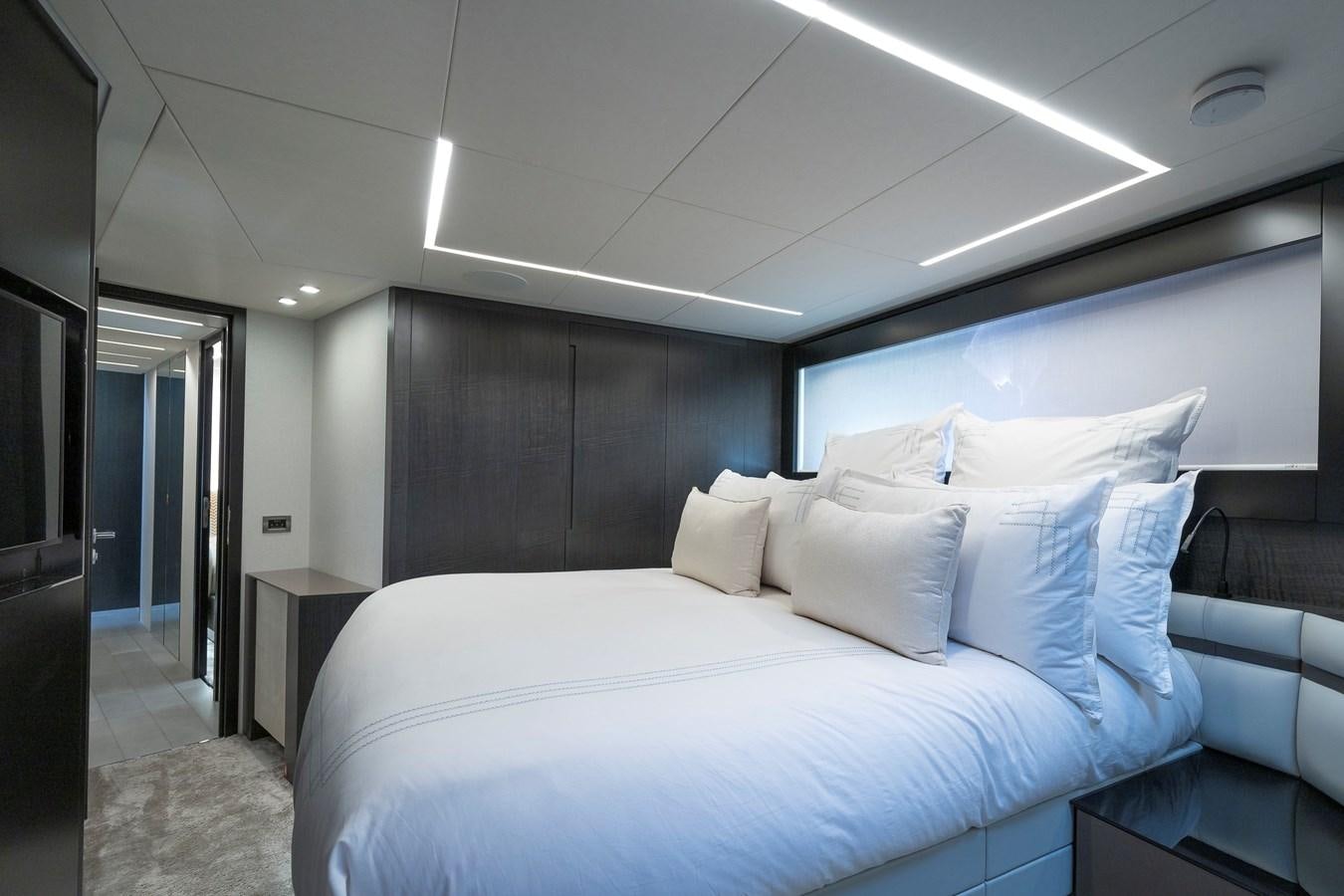 a bed in a room aboard BOMBADIL III Yacht for Sale