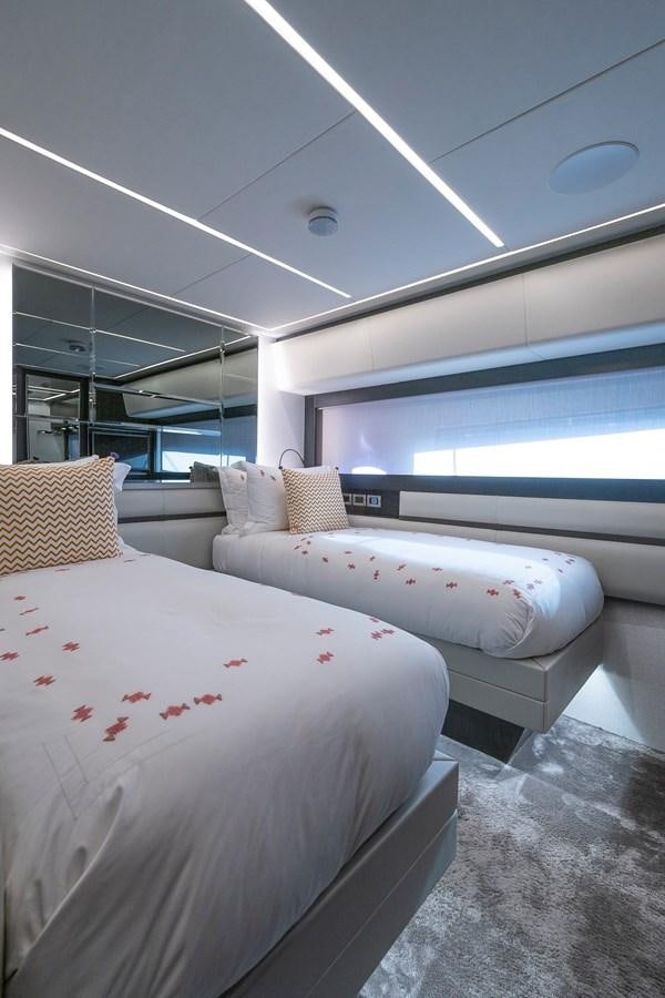 a room with a couple of beds aboard BOMBADIL III Yacht for Sale