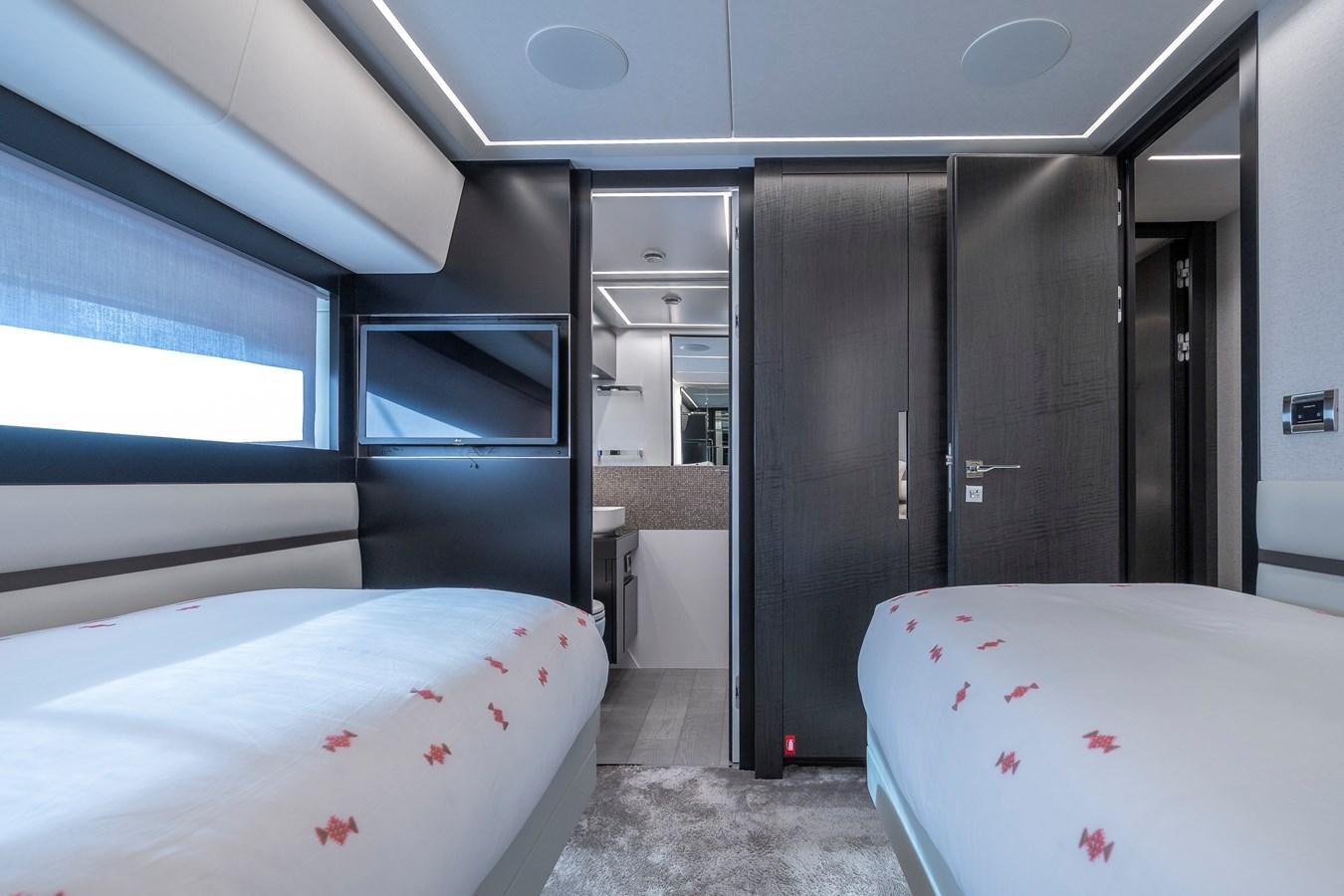 a room with a bed and a closet aboard BOMBADIL III Yacht for Sale