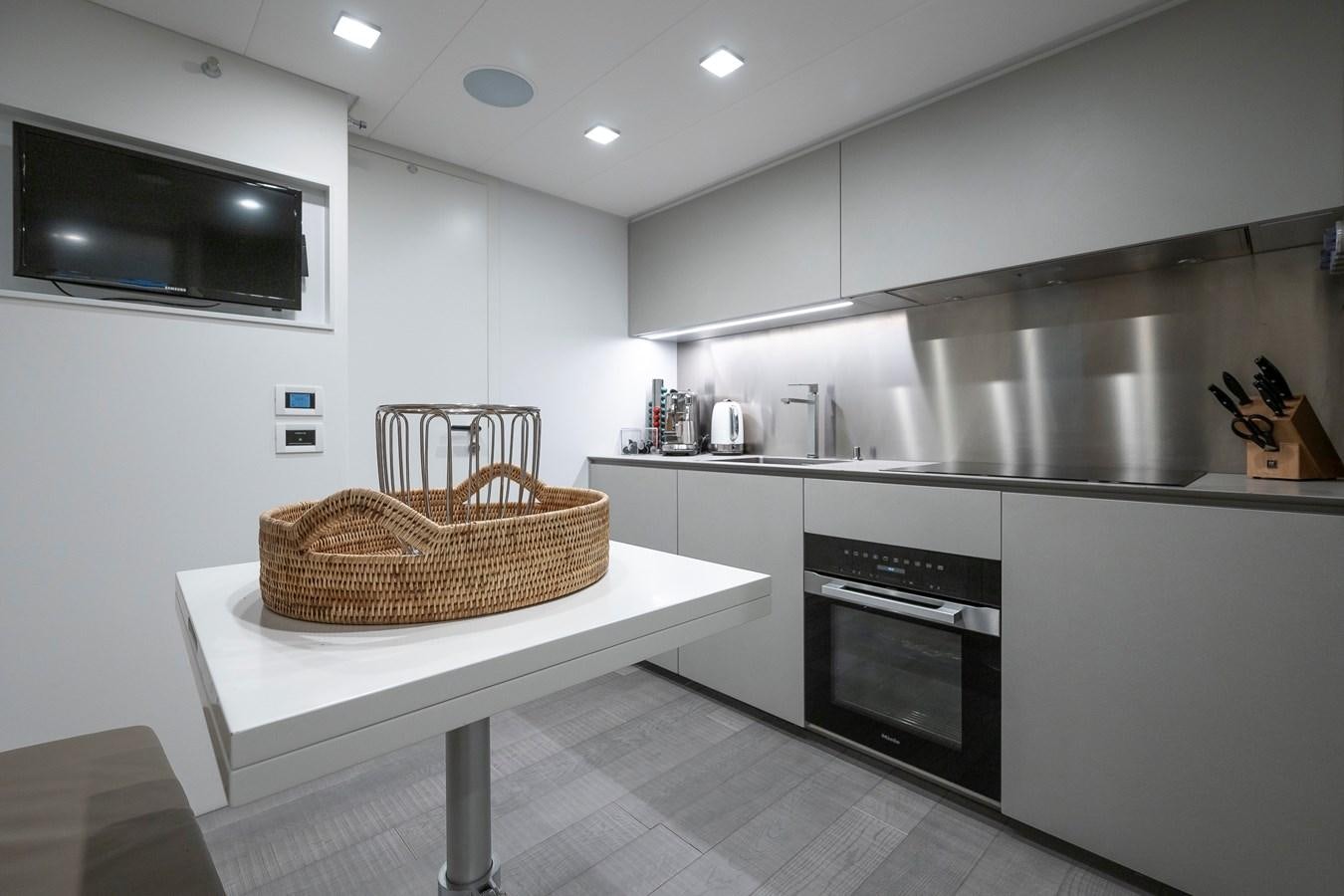a kitchen with a basket on the counter aboard BOMBADIL III Yacht for Sale
