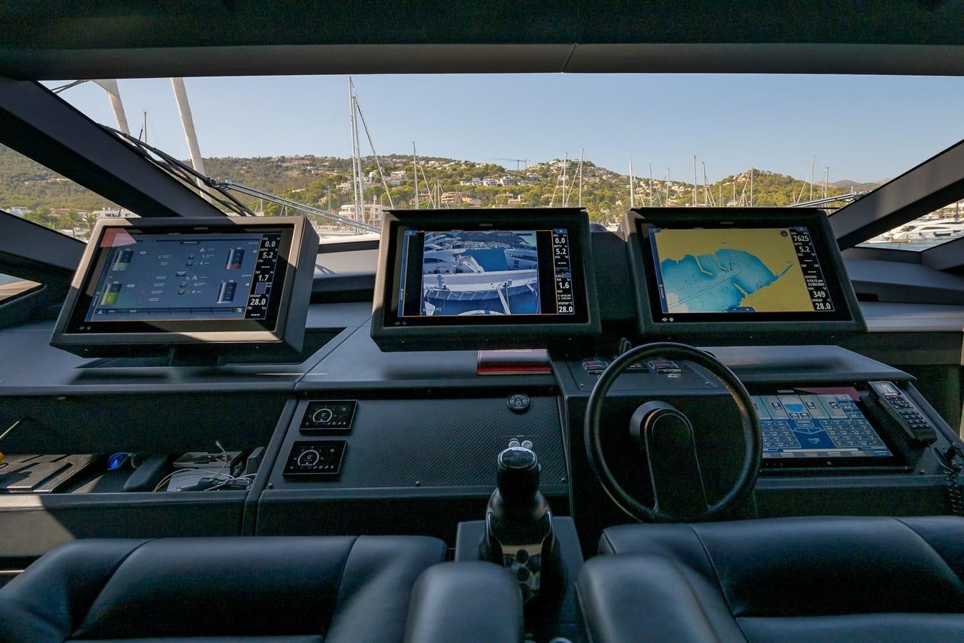 a car with a screen and a monitor on the dashboard aboard BOMBADIL III Yacht for Sale
