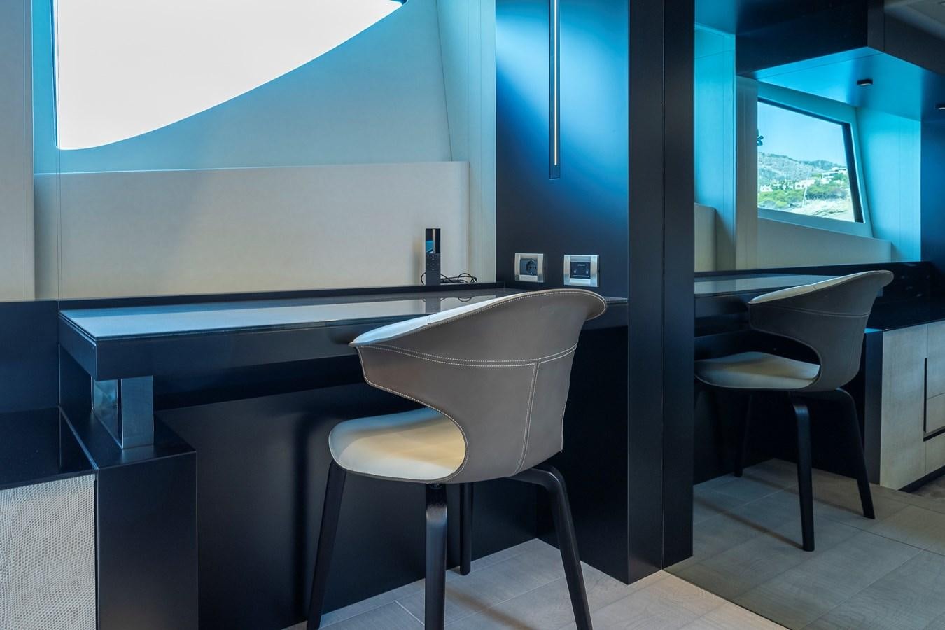 a room with a table and chairs aboard BOMBADIL III Yacht for Sale
