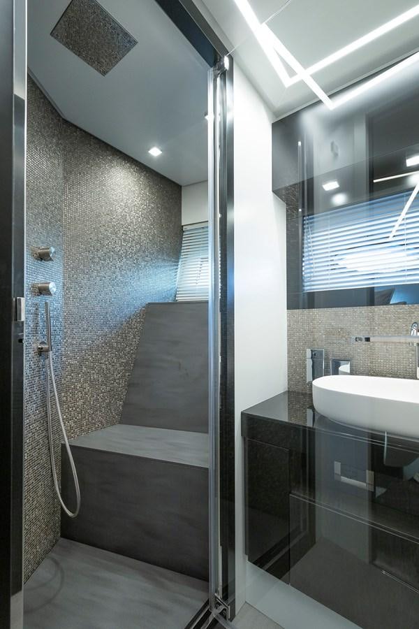 a bathroom with a glass shower aboard BOMBADIL III Yacht for Sale