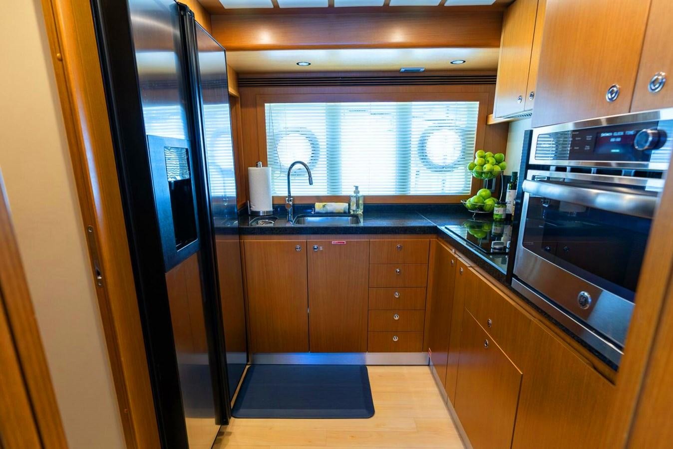 a kitchen with wooden cabinets aboard ALTURA 840 Yacht for Sale