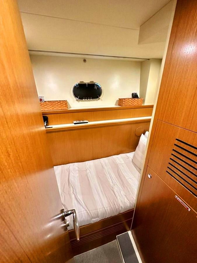 a white bed with a black pillow on it aboard ALTURA 840 Yacht for Sale