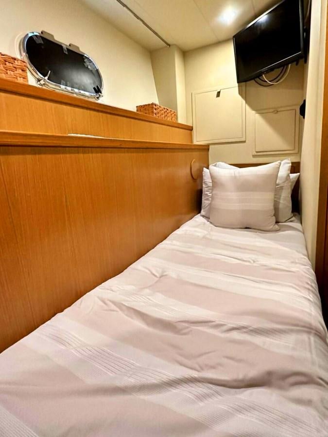 a bed with a white pillow and a black helmet on top aboard ALTURA 840 Yacht for Sale