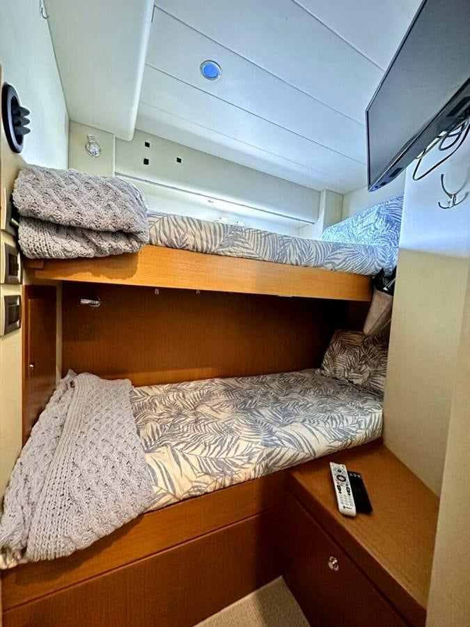 a bed with a pillow and a remote aboard ALTURA 840 Yacht for Sale
