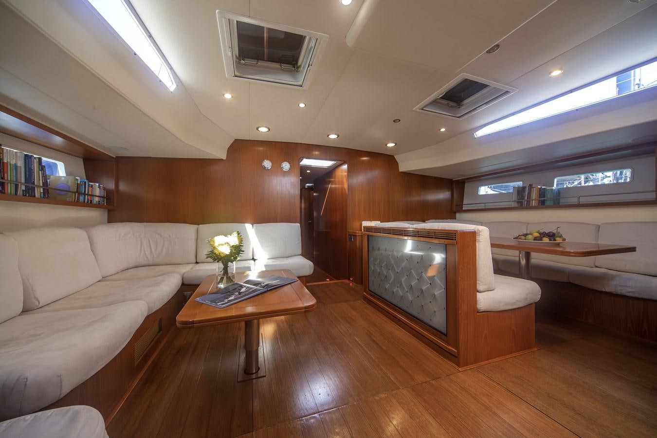 a living room with a couch and a coffee table aboard TURCONERI Yacht for Sale