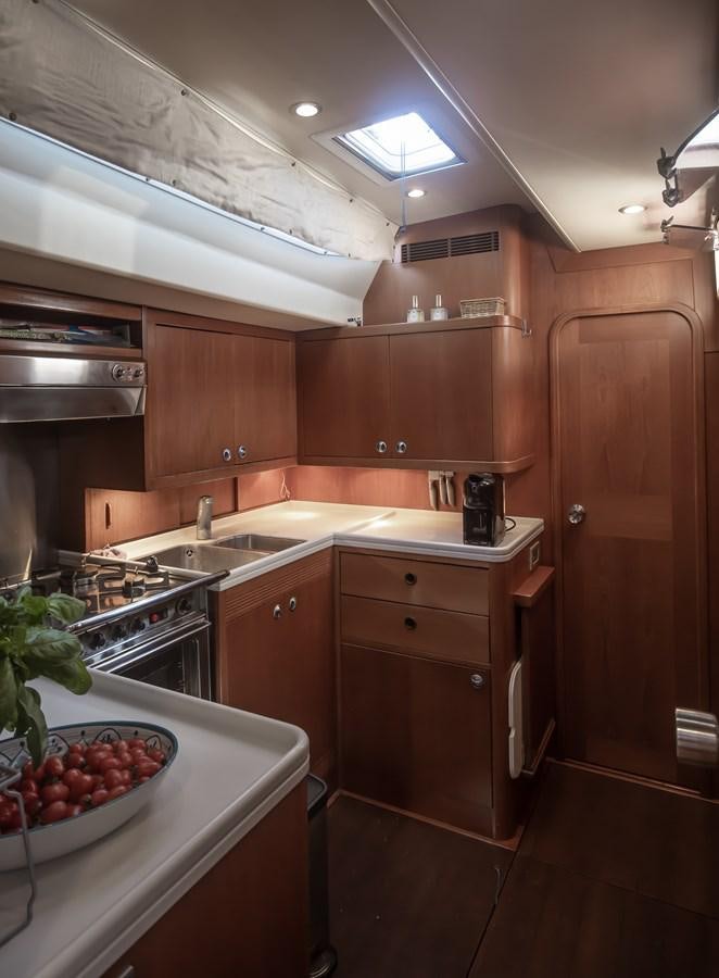 a kitchen with wooden cabinets aboard TURCONERI Yacht for Sale