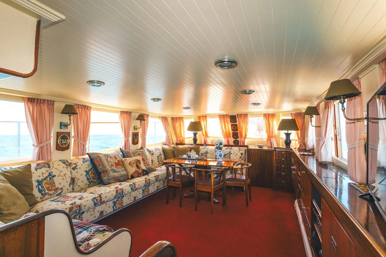 a living room with a red rug aboard SILVER CAVALIER Yacht for Sale