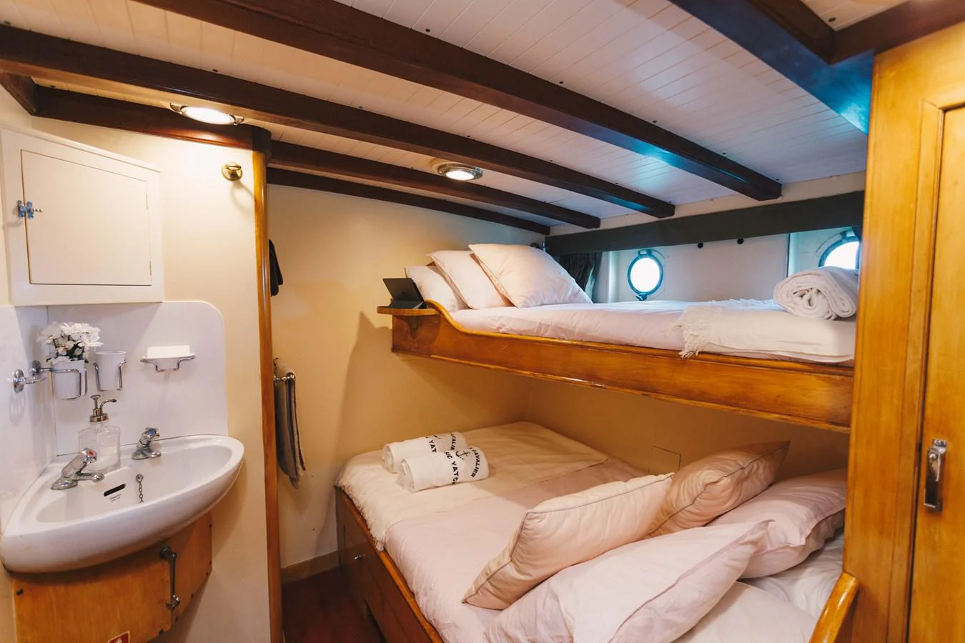 a small room with a bed and a sink aboard SILVER CAVALIER Yacht for Sale