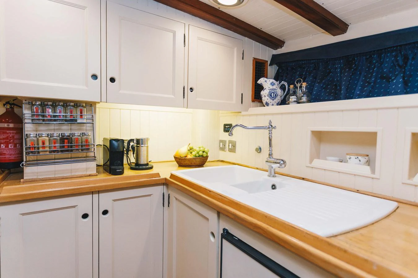 a kitchen with white cabinets aboard SILVER CAVALIER Yacht for Sale