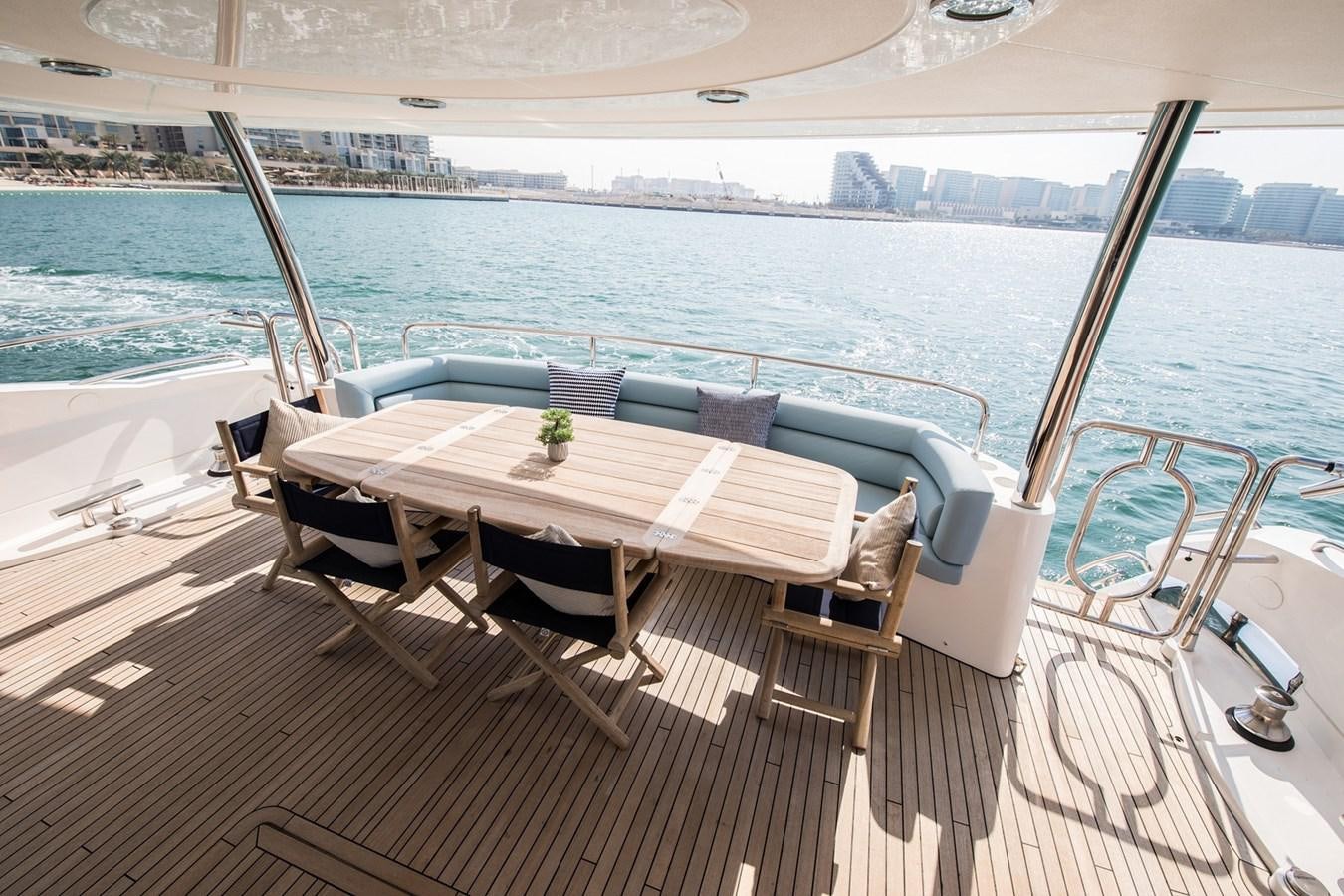 a table and chairs on a deck overlooking a body of water aboard 2008 SUNSEEKER 90 Yacht for Sale
