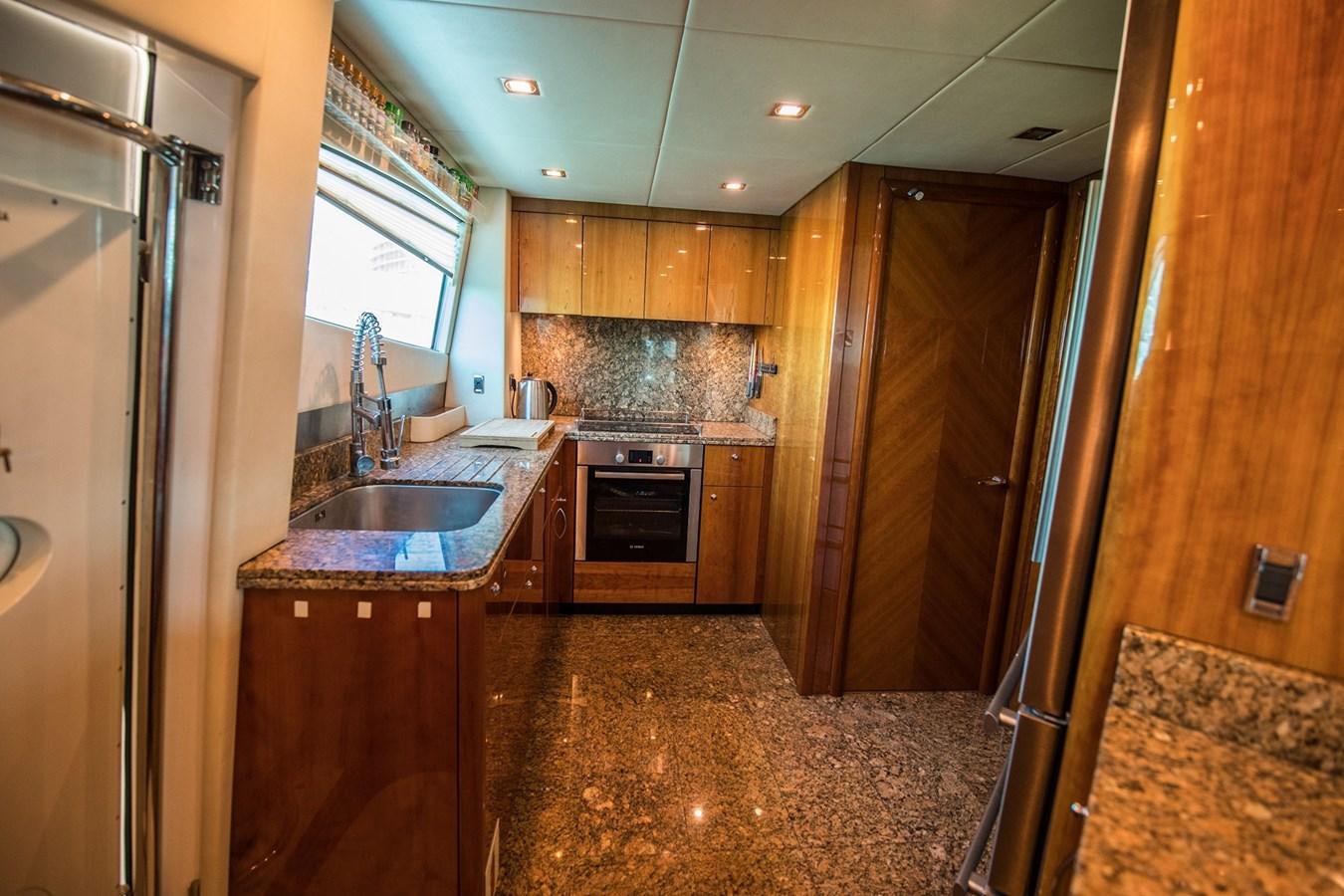 a kitchen with wooden cabinets aboard 2008 SUNSEEKER 90 Yacht for Sale