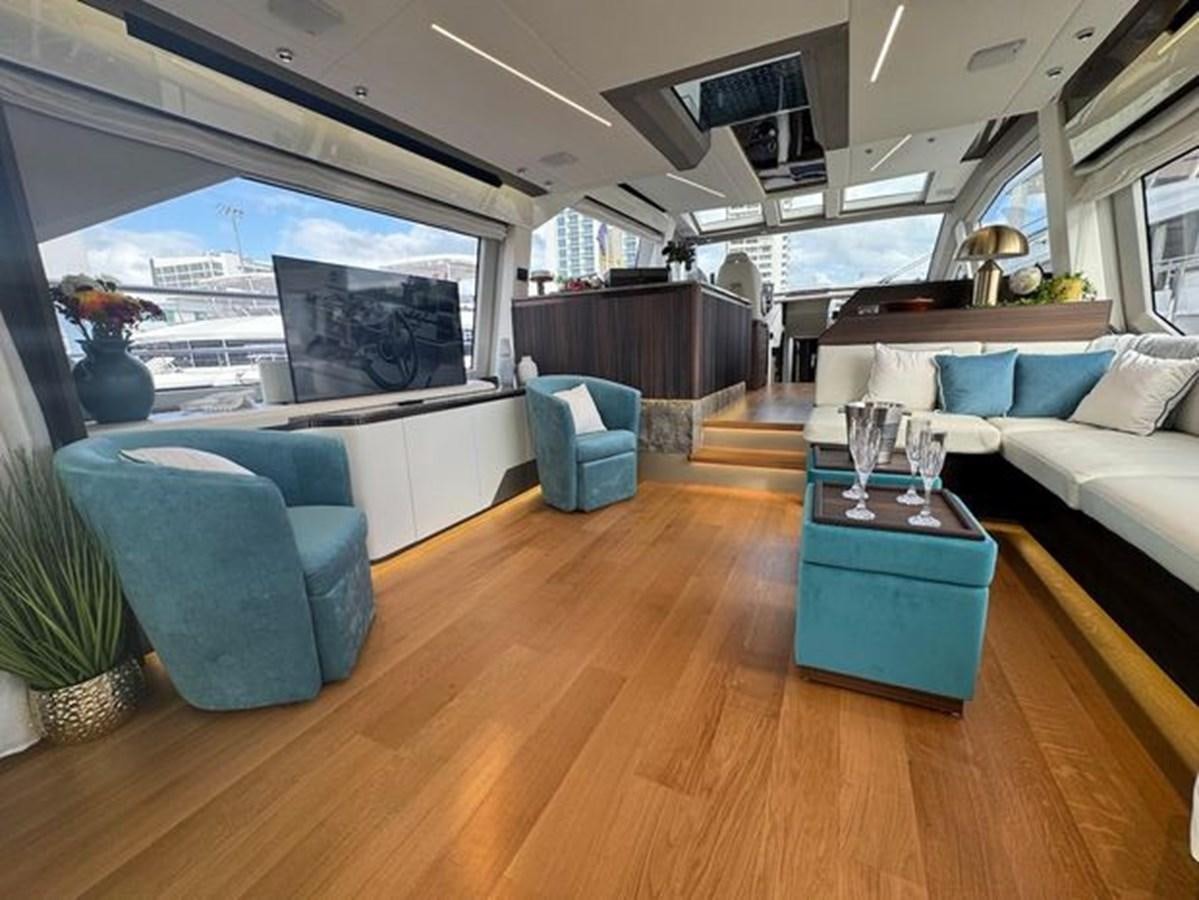 a living room with a large window aboard AICON 66 VIVERE Yacht for Sale