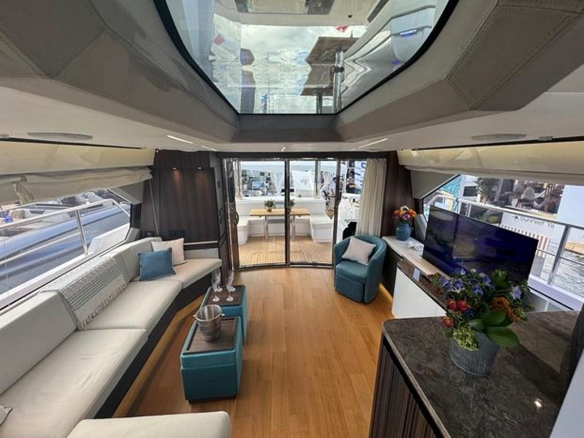 a living room with a large window aboard AICON 66 VIVERE Yacht for Sale