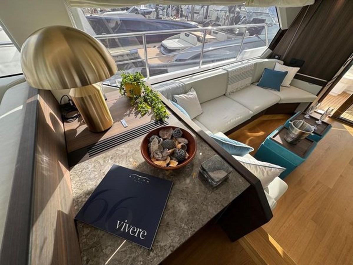 a living room with a large window aboard AICON 66 VIVERE Yacht for Sale