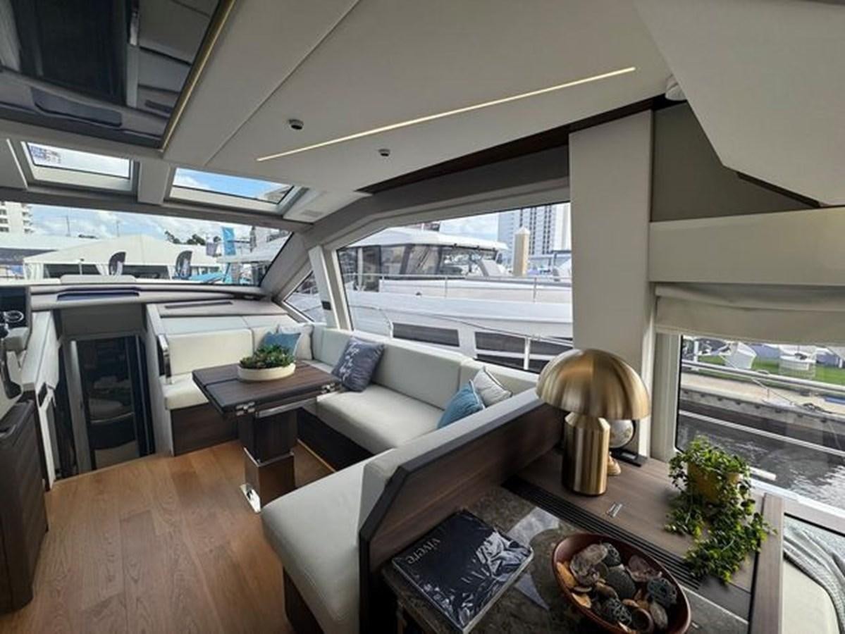 a living room with a large window aboard AICON 66 VIVERE Yacht for Sale