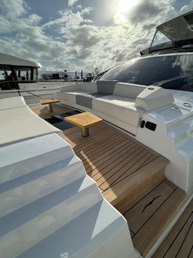 a deck with a table and chairs aboard AICON 66 VIVERE Yacht for Sale
