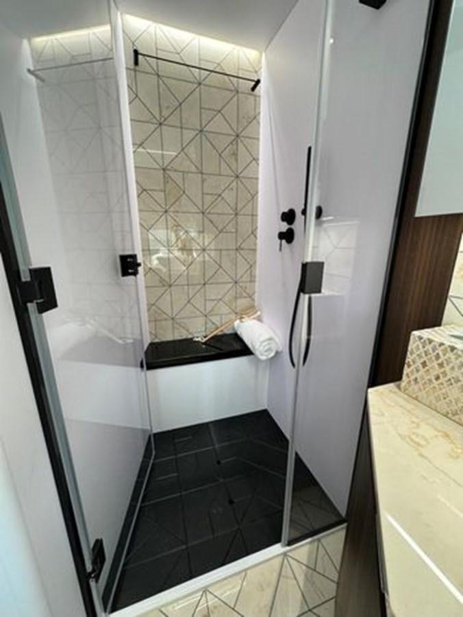a bathroom with a glass shower aboard AICON 66 VIVERE Yacht for Sale