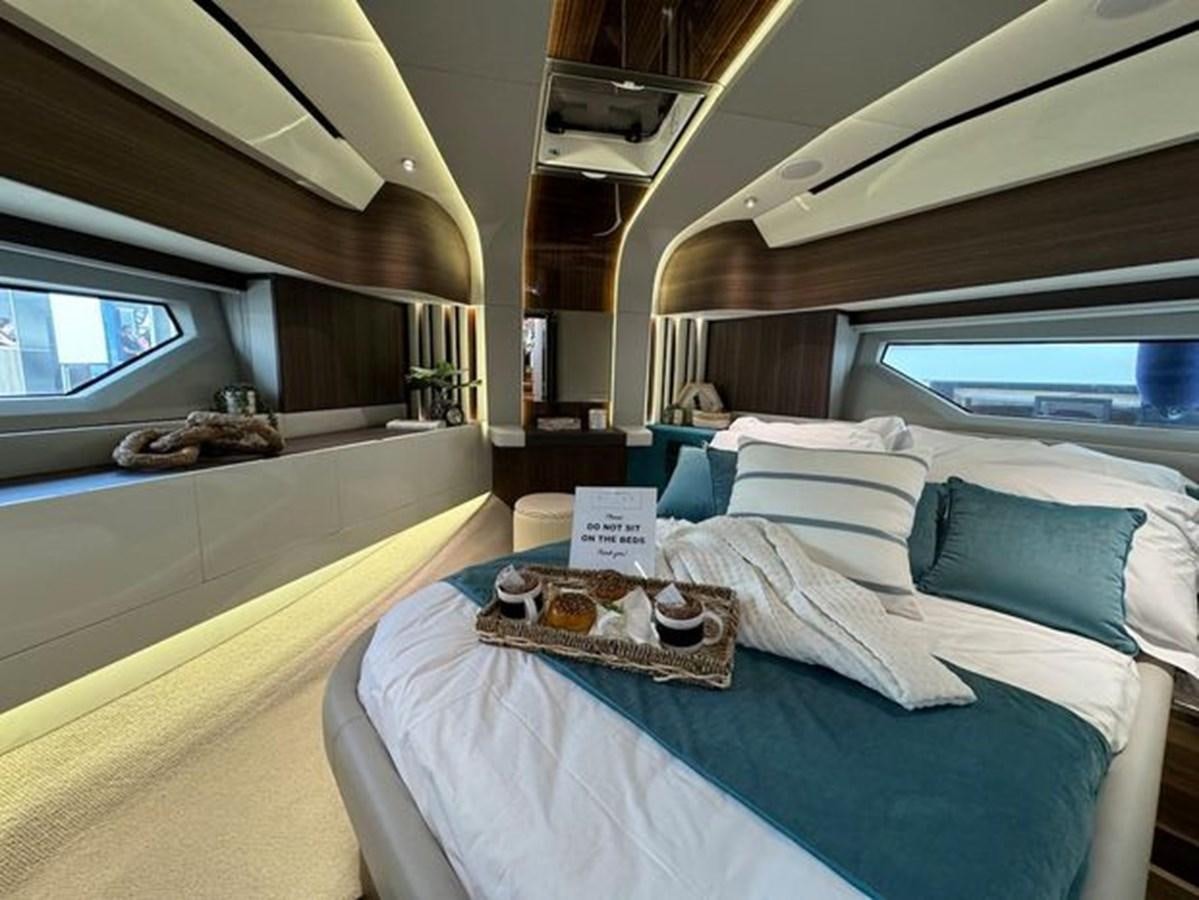 a bed with a blue sheet aboard AICON 66 VIVERE Yacht for Sale
