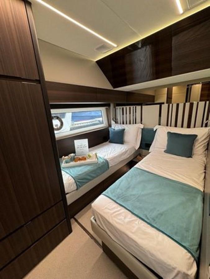 a room with a bed and a window aboard AICON 66 VIVERE Yacht for Sale