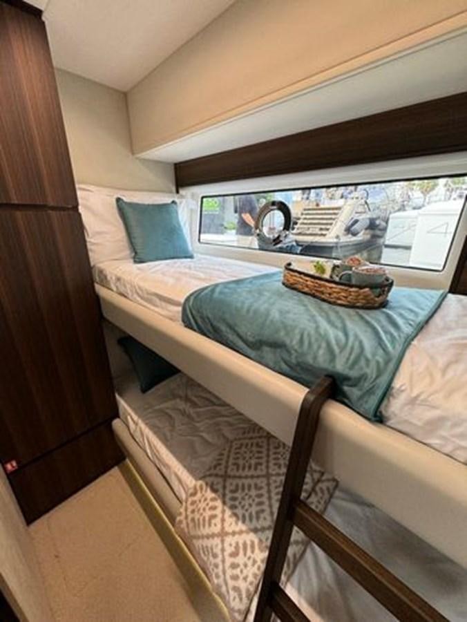 a bed with a blue sheet aboard AICON 66 VIVERE Yacht for Sale