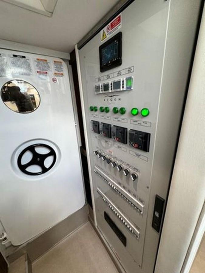 a white machine with green lights aboard AICON 66 VIVERE Yacht for Sale
