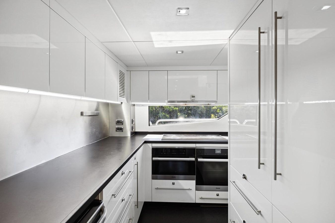 a kitchen with white cabinets aboard SEAHORSE Yacht for Sale
