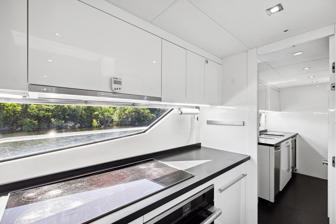 a kitchen with white cabinets aboard SEAHORSE Yacht for Sale