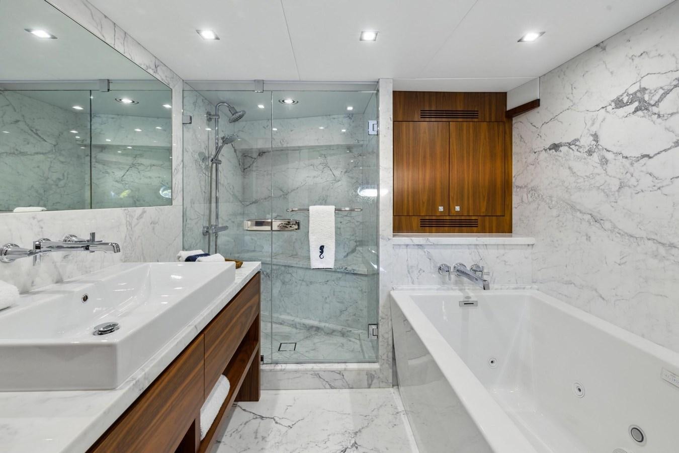a bathroom with a tub sink and a shower unit aboard SEAHORSE Yacht for Sale